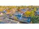 Aerial view of home showcasing fenced backyard with fire pit and seating in a well-established neighborhood at 5541 Umatilla St, Denver, CO 80221