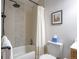 Bathroom features a tile shower with modern fixtures, a toilet and vanity at 5541 Umatilla St, Denver, CO 80221