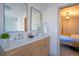 Well-lit bathroom features a dual sink vanity with modern fixtures and tile at 5541 Umatilla St, Denver, CO 80221