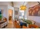 Stylish dining room featuring modern light fixtures and a view to the living area at 5541 Umatilla St, Denver, CO 80221