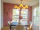 Cozy dining room featuring a large window, stylish chandelier, and modern decor at 5541 Umatilla St, Denver, CO 80221