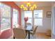 Bright dining room with large windows, modern lighting, and warm, neutral tones at 5541 Umatilla St, Denver, CO 80221