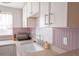 Bright kitchen with stainless steel faucet, light countertops, and fresh white cabinets at 5541 Umatilla St, Denver, CO 80221