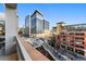 Balcony view showcasing pedestrian bridge and striking city architecture at 1610 Little Raven St # Ph6, Denver, CO 80202