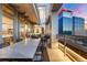 Spacious covered balcony featuring upscale outdoor dining with city views at sunset at 1610 Little Raven St # Ph6, Denver, CO 80202