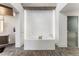 Sleek bathroom showcasing a soaking tub, decorative tile, and frosted glass door at 1610 Little Raven St # Ph6, Denver, CO 80202