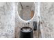 Stylish half-bathroom with dark granite sink and elegant floral wallpaper at 1610 Little Raven St # Ph6, Denver, CO 80202