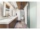 Modern bathroom featuring a wood ceiling accent, stylish vanity, and a frosted glass sliding door at 1610 Little Raven St # Ph6, Denver, CO 80202