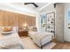 Bright bedroom with two twin beds, wood accent wall, and modern decor at 1610 Little Raven St # Ph6, Denver, CO 80202