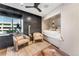 Modern bedroom with sitting area, window view, and built-in bed at 1610 Little Raven St # Ph6, Denver, CO 80202