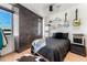 Cozy bedroom with a dark accent wall, decorative shelving, and unique decor at 1610 Little Raven St # Ph6, Denver, CO 80202