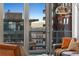 The city view from inside the residence shows balconies and the distant mountains at 1610 Little Raven St # Ph6, Denver, CO 80202