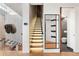 Modern entryway boasts striking staircase with illuminated steps and designer details at 1610 Little Raven St # Ph6, Denver, CO 80202