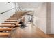Modern entryway with floating staircase, wood floors, and designer accents at 1610 Little Raven St # Ph6, Denver, CO 80202