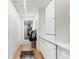 Hallway with built-in storage, mirror, and wood floors at 1610 Little Raven St # Ph6, Denver, CO 80202