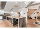 Spacious open kitchen with an island and seating, adjacent to the living area and stairs at 1610 Little Raven St # Ph6, Denver, CO 80202