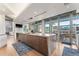 Modern kitchen island with wooden cabinetry and sliding glass doors to outdoor patio at 1610 Little Raven St # Ph6, Denver, CO 80202