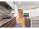 Modern kitchen featuring high-end appliances, marble backsplash, and custom cabinetry at 1610 Little Raven St # Ph6, Denver, CO 80202