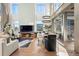 Open-concept living area with fireplace, large windows, and modern lighting fixtures at 1610 Little Raven St # Ph6, Denver, CO 80202
