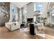 Bright and airy living room with high ceilings, large windows, and hardwood floors at 1610 Little Raven St # Ph6, Denver, CO 80202