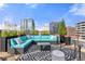 Expansive rooftop deck featuring cozy sectional seating and stunning city views at 1610 Little Raven St # Ph6, Denver, CO 80202