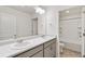 Bathroom with double sinks, light grey cabinets, and a shower-tub combo for modern living at 4743 Hatcher Dr, Brighton, CO 80601