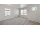 Bright bedroom with three windows, neutral carpet, and ample natural light creating a comfortable space at 4743 Hatcher Dr, Brighton, CO 80601