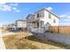 View of a charming two-story home with a covered front porch and landscaped yard at 4743 Hatcher Dr, Brighton, CO 80601