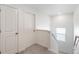 Hallway features carpet flooring, a window, and two doors at 4743 Hatcher Dr, Brighton, CO 80601