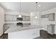 Bright kitchen with recessed lights features granite countertops, stainless appliances, grey cabinets at 4743 Hatcher Dr, Brighton, CO 80601