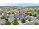 Community aerial view showcasing multiple homes, landscape, and beautiful neighborhood with rolling hills in the background at 3717 Desert Ridge Cir, Castle Rock, CO 80108