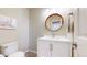 Charming half bathroom with a modern vanity, round mirror, and stylish fixtures at 3717 Desert Ridge Cir, Castle Rock, CO 80108