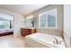 Bathroom featuring double sinks, a separate tub, and a window with blinds at 3717 Desert Ridge Cir, Castle Rock, CO 80108
