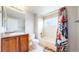 Clean bathroom with a shower-tub combo, featuring a stylish curtain and wood vanity at 3717 Desert Ridge Cir, Castle Rock, CO 80108