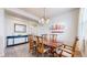 Elegant dining room with hardwood floors, a wooden table, and decorative lighting at 3717 Desert Ridge Cir, Castle Rock, CO 80108