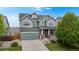 Charming two-story home boasts a well-manicured lawn, inviting curb appeal, and an attached two-car garage at 3717 Desert Ridge Cir, Castle Rock, CO 80108