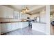 Modern kitchen featuring white cabinets, stainless steel appliances, granite countertops, and hardwood floors at 3717 Desert Ridge Cir, Castle Rock, CO 80108