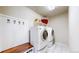 Efficient laundry room with modern washer, dryer, and ample storage and hanging space at 3717 Desert Ridge Cir, Castle Rock, CO 80108