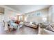 Bright living room featuring hardwood floors, neutral tones, and comfortable seating with an open dining area at 3717 Desert Ridge Cir, Castle Rock, CO 80108