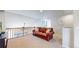 Cozy loft area with a comfortable leather sofa, railing view to the level below and carpeted floors at 3717 Desert Ridge Cir, Castle Rock, CO 80108