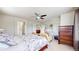 Bright main bedroom featuring a ceiling fan, TV, seating area, and an ensuite bathroom with a glass shower at 3717 Desert Ridge Cir, Castle Rock, CO 80108