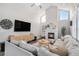 Bright living room boasts vaulted ceilings, a cozy fireplace, modern furnishings, and neutral color tones at 13340 Saint Paul St, Thornton, CO 80241