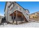 Backyard with a covered patio, deck with stairs, and a modern two-story home's architectural details and yard at 3438 Cade Ct, Castle Rock, CO 80104