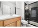 Modern bathroom features a stylish vanity, a sleek toilet, and a shower with a glass door and dark tile surround at 3438 Cade Ct, Castle Rock, CO 80104