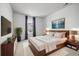 Stylish bedroom featuring a wooden bed frame, modern decor, and a large window for ample natural light at 3438 Cade Ct, Castle Rock, CO 80104
