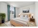 Bright bedroom featuring a large window, modern artwork, and comfortable bedding for a relaxing atmosphere at 3438 Cade Ct, Castle Rock, CO 80104