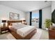 Comfortable bedroom featuring a stylish wooden headboard, plush rug, and bright window view at 3438 Cade Ct, Castle Rock, CO 80104