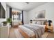 Cozy bedroom with a full sized bed, large window, stylish lamps and modern decor create a relaxing atmosphere at 3438 Cade Ct, Castle Rock, CO 80104