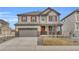 Charming two-story home with a gray exterior, red shutters, and attached two-car garage at 3438 Cade Ct, Castle Rock, CO 80104
