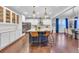 Bright kitchen with white cabinets, stainless steel appliances, pendant lighting and a large center island with bar stool seating at 3438 Cade Ct, Castle Rock, CO 80104